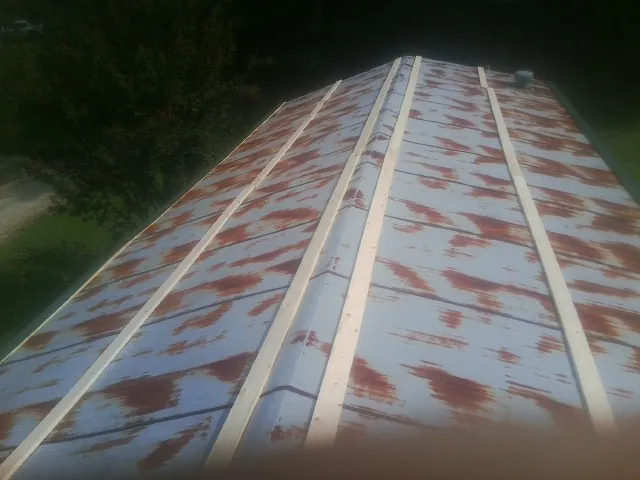 Rusted metal roof panels with new wood purlins before replacement — Storm Damage Roof Repair in Alpine by Roofing Brothers